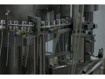 Llenadora gravitacional con tapadora a presión, envasado de perfumes
